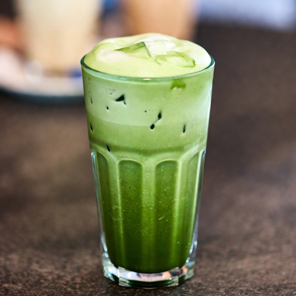 An Iced Matcha Latte With Foam — Food Photography